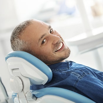 A man smiles in the dentist chair