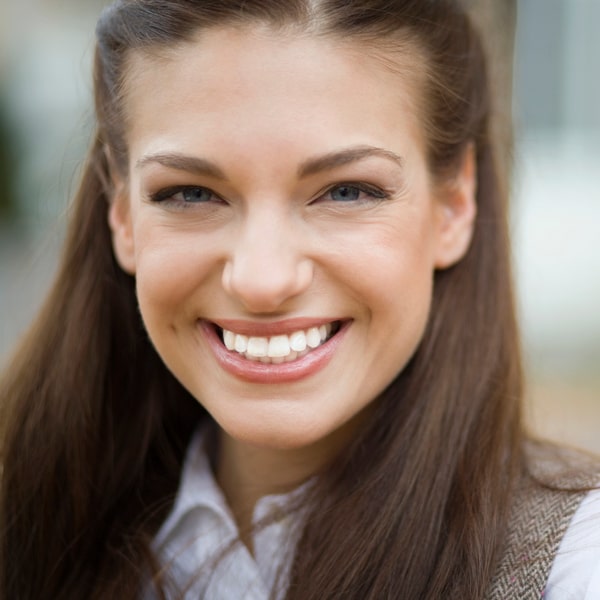 A woman with porcelain veneers smiling
